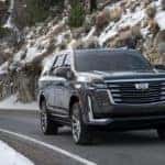 2021 Cadillac Excalade driving down a snowy road