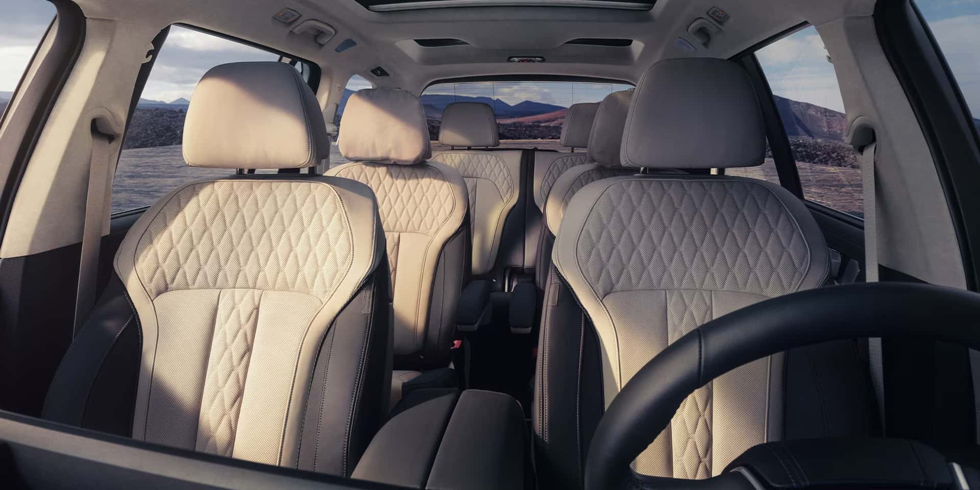 the interior of a bmw x7 showcasing the light beige leather interior