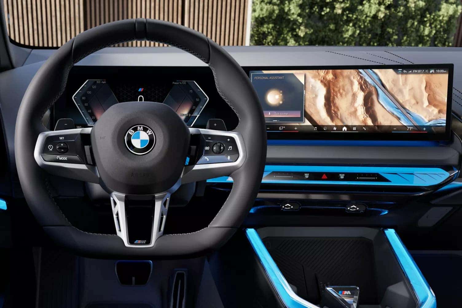 Driver’s view of the 2025 BMW X3 cockpit featuring a digital gauge cluster, curved touchscreen display with navigation, and M Sport steering wheel.