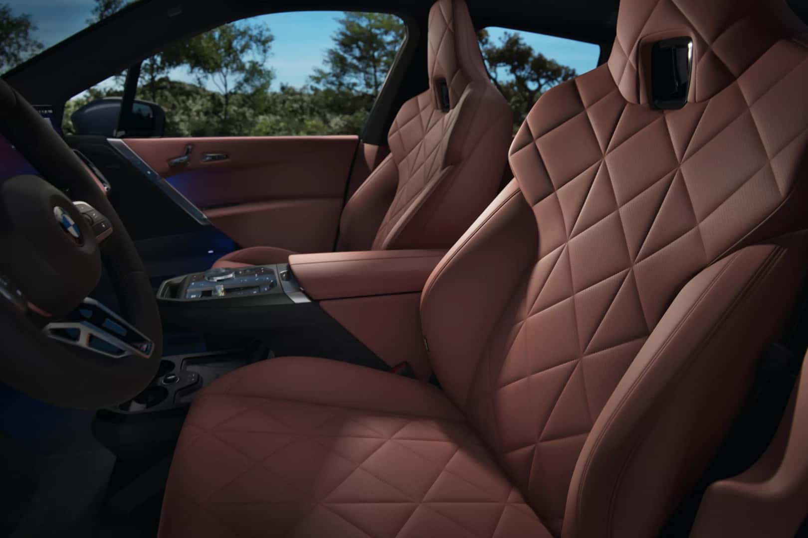 the front interior of a 2026 iX with beige leather interior seats