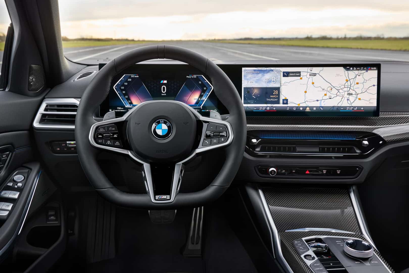 2025 BMW 3 Series interior with M Sport steering wheel, digital gauge cluster, and widescreen infotainment display featuring navigation and weather apps.