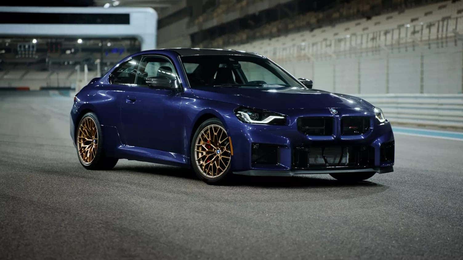 2026 bmw 2 series in dark blue parked on a race track