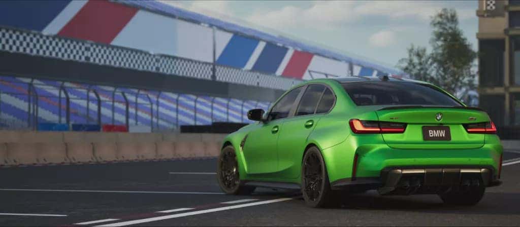 a green bmw parked on a race track