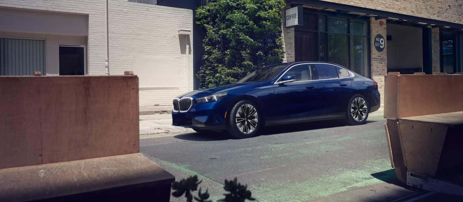 a 2026 BMW 5 Series parked next to a building