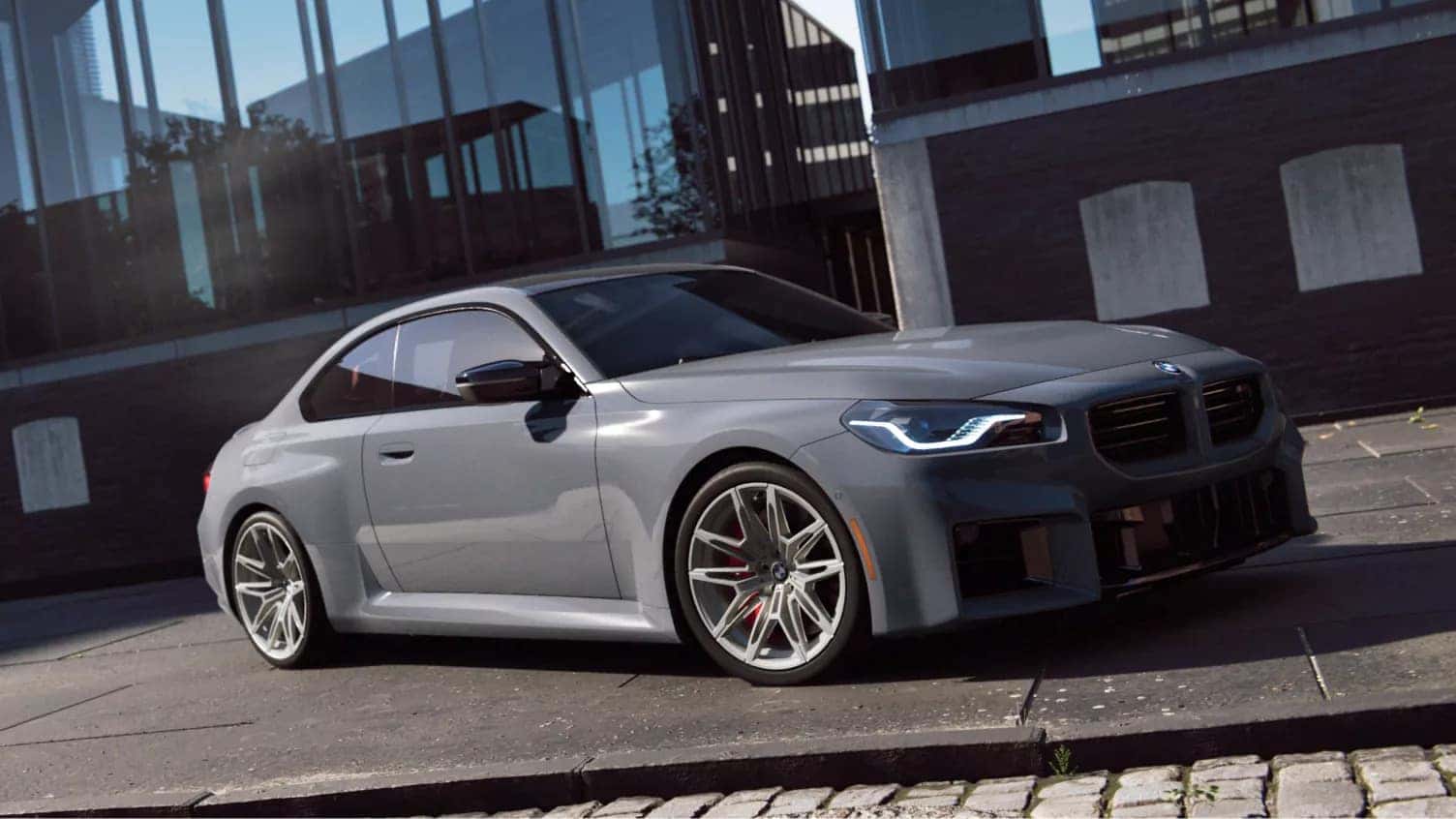 a grey 2026 BMW 2 Series parked outside of a building