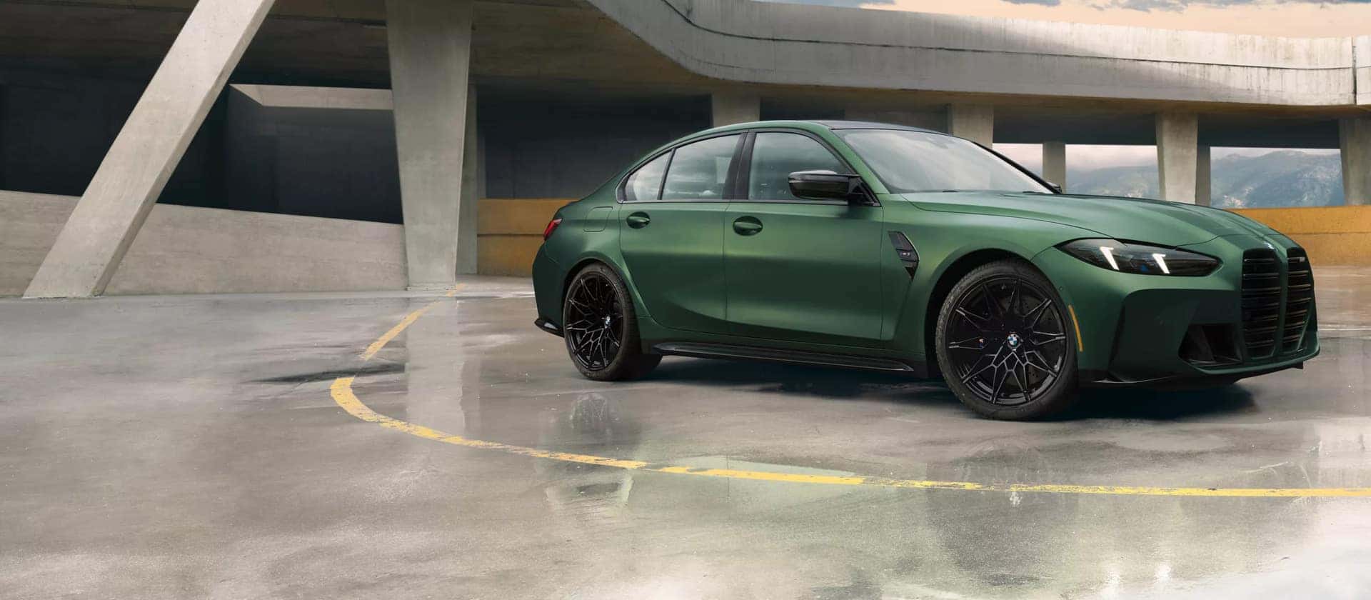 a green BMW 3 Series Parked in a parking garage