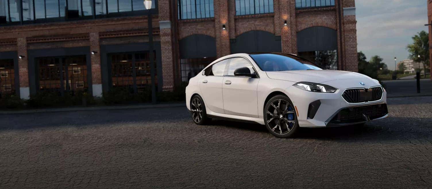 a white 2026 BMW 2 Series parked outside of a brick building