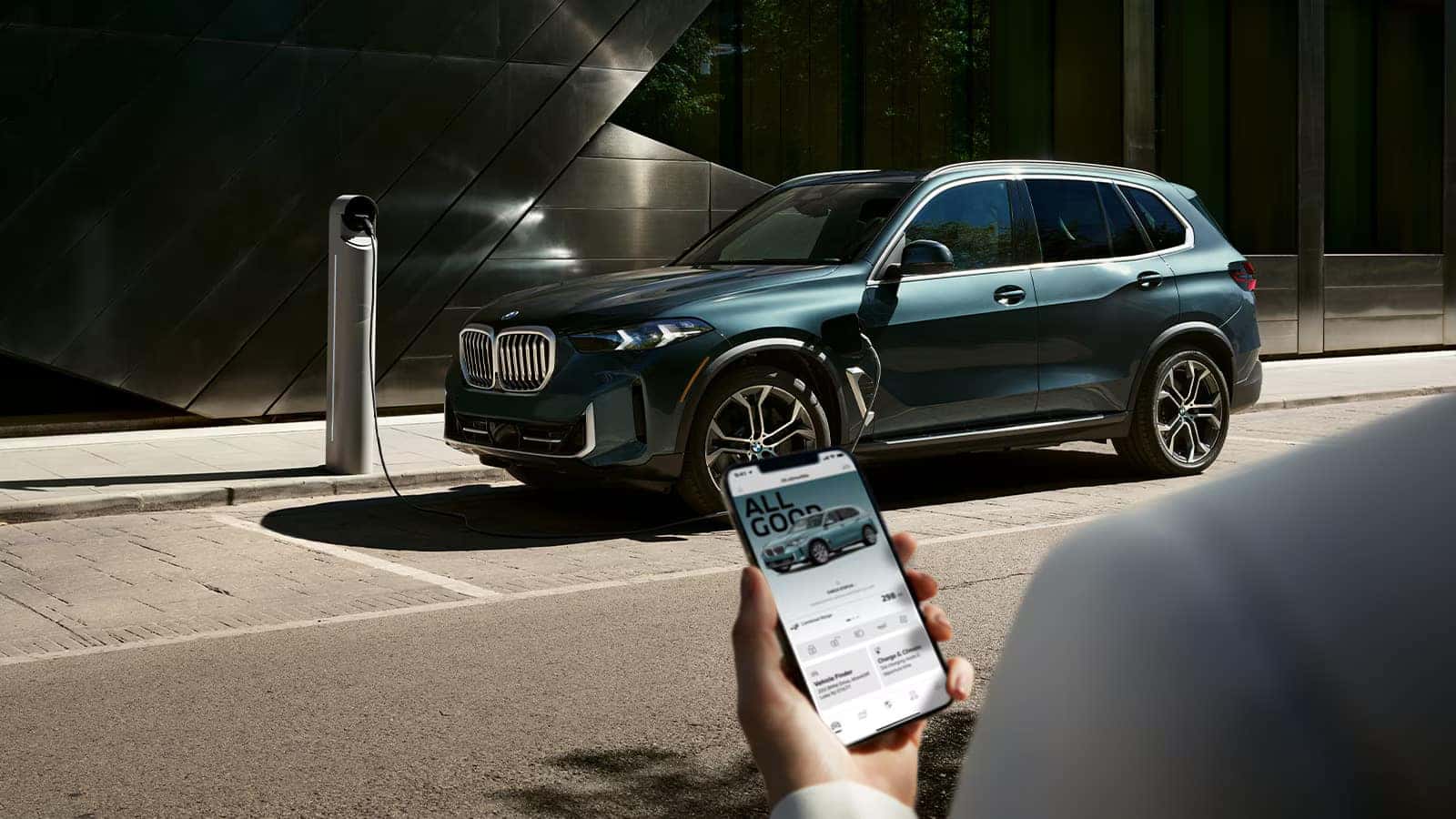 a 2026 BMW X5 parked at a charging station
