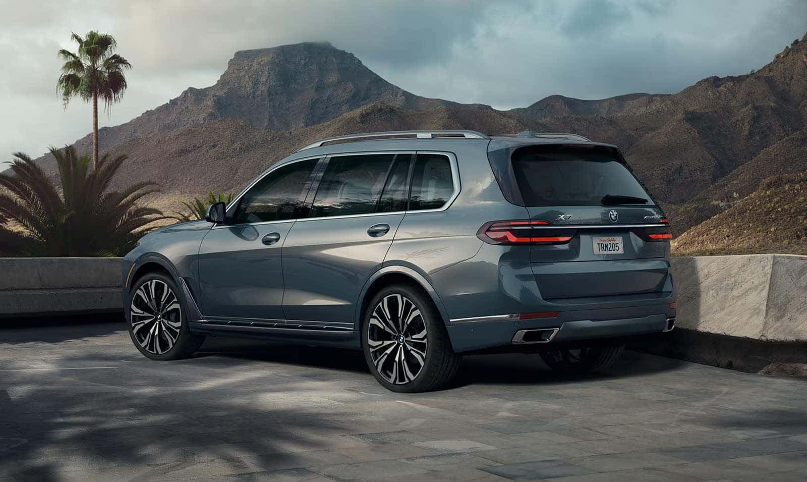 a 2026 BMW X7 parked next to a mountain range
