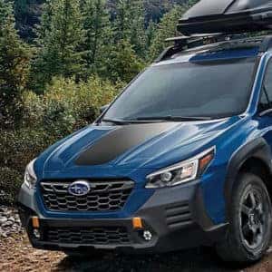Blue Subaru SUV on mountain trail 600x600