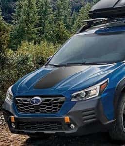 Blue Subaru SUV on mountain trail 600x700