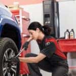 Woman performing Toyota service on a vehicle