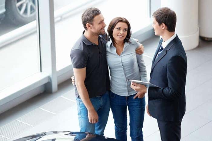 A couple talking with a sales rep about Toyota financing