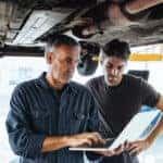 Technicians inspecting vehicle