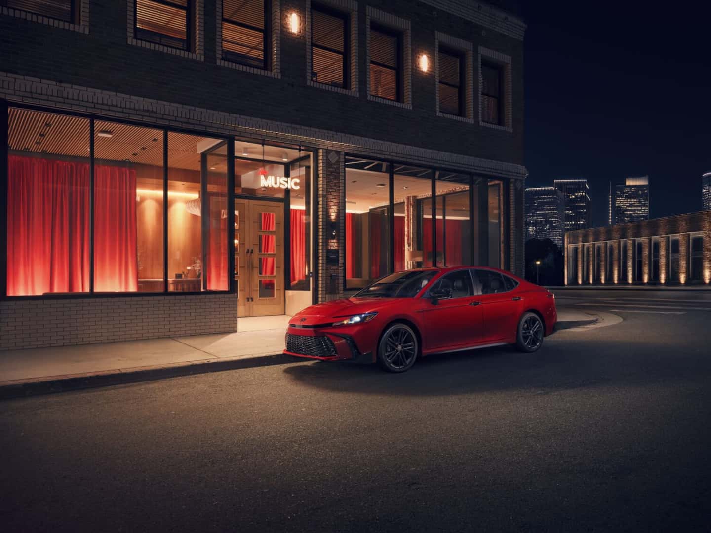 2026 Toyota Camry parked outside a venue at night