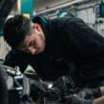 Mechanic working under the hood of a car