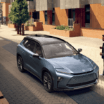 Man walking up to 2026 Toyota Crown Signia parked in the city
