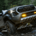 2026 Toyota Tacoma driving over rocks in the forest
