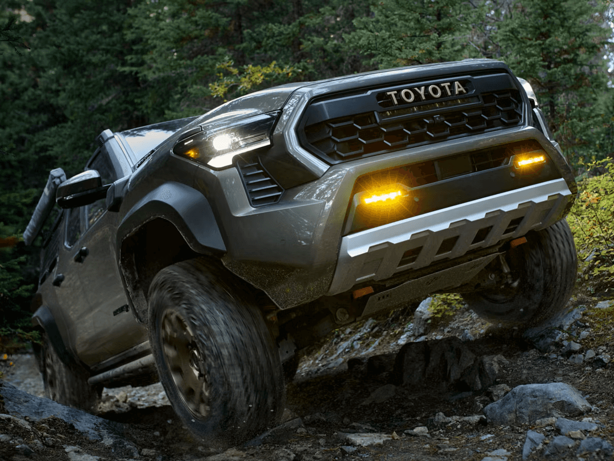 2026 Toyota Tacoma driving over rocks in the forest