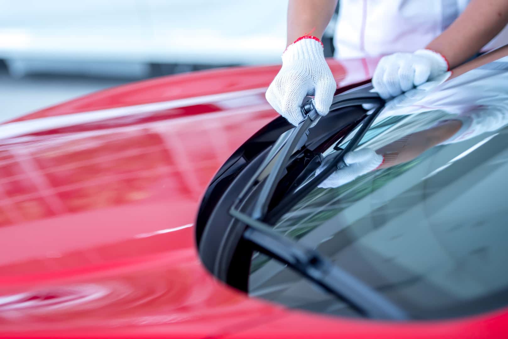 Mechanic replacing windshield wiper blades