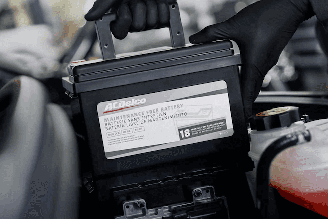 Mechanic replacing car battery