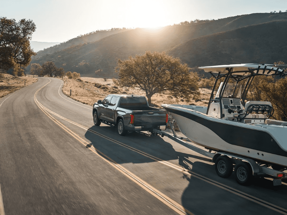 2026 Toyota Tundra towing a boat on the road