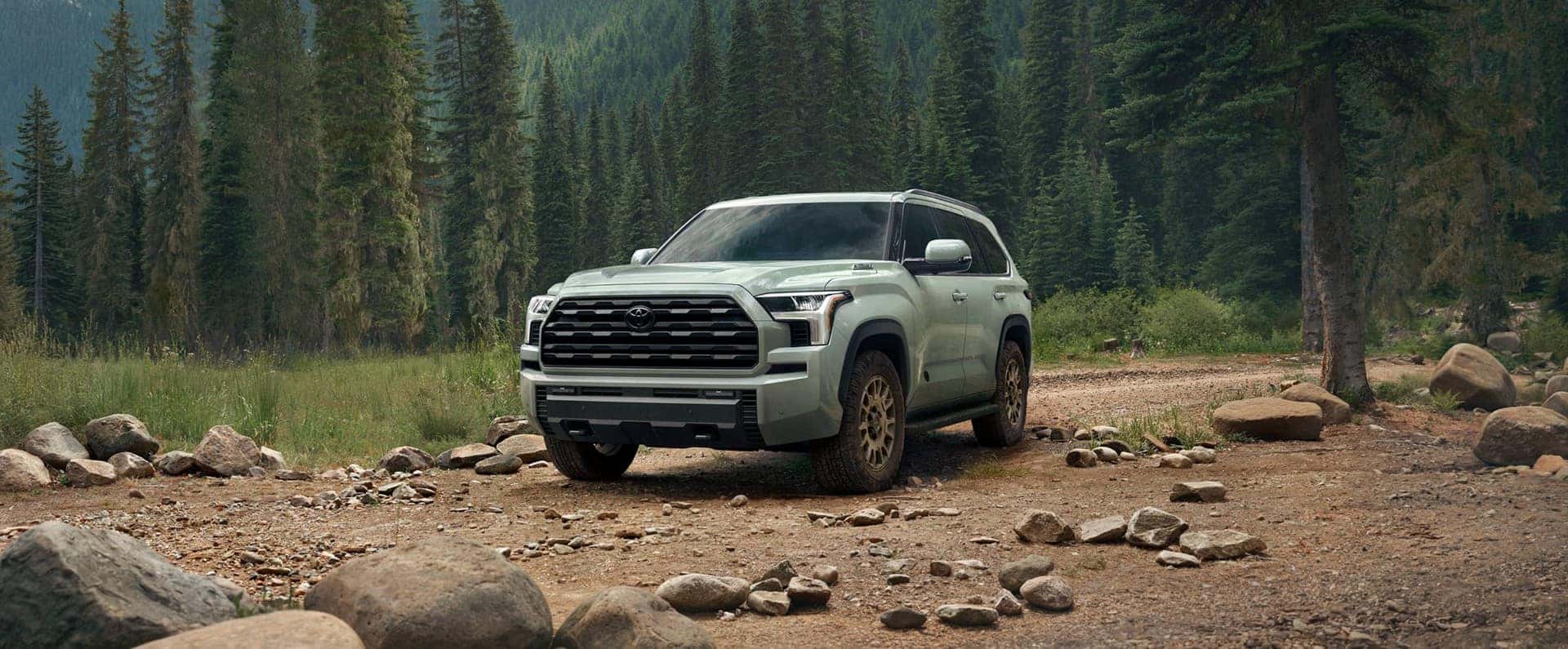 Light Green 2027 Toyota Sequoia Parked on rocky forest trail