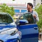 Man getting into 2018 Toyota Corolla