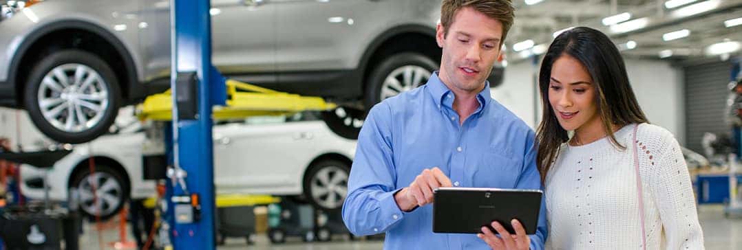 How to check your tires' health at Washington Hyundai of Washington | Mechanic showing customer proper tire pressure limits on tablet