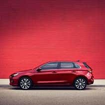 Hyundai Hybrid for Everyone at Washington Hyundai | Side of Elantra next to red wall