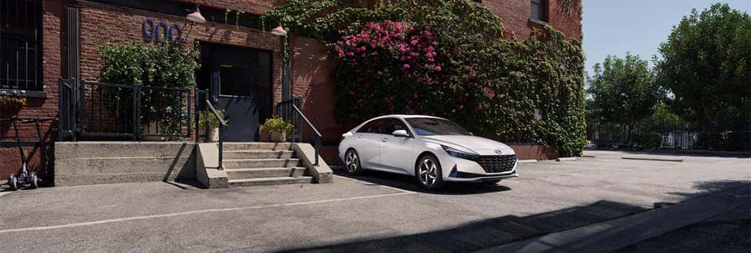 Hyundai Hybrid for Everyone at Washington Hyundai | Elantra parked outside downtown brick building