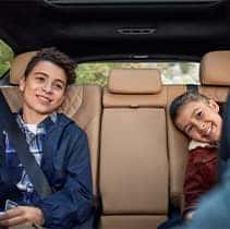 Hyundai Hybrid for Everyone at Washington Hyundai | Two kids happy in the back seats of Santa Fe