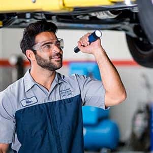 How to prepare your Hyundai for the winter season in Washington, PA at Washington Hyundai | Mechanic checks under car for rust or leaks