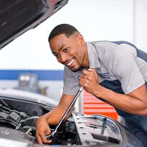 How to prepare your Hyundai for the winter season in Washington, PA at Washington Hyundai | Mechanic tightens bolts in engine bay