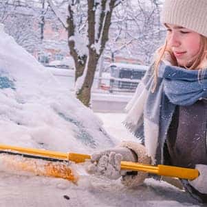 How to prepare your Hyundai for the winter season in Washington, PA at Washington Hyundai | Woman clears off snow from her windshield