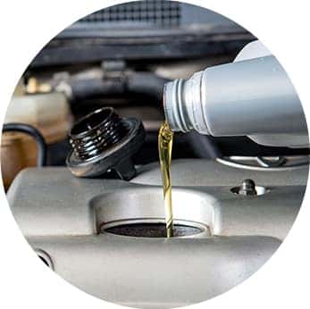 Difference between synthetic oil & conventional oil at Washington Hyundai | Close-up of oil being poured into engine