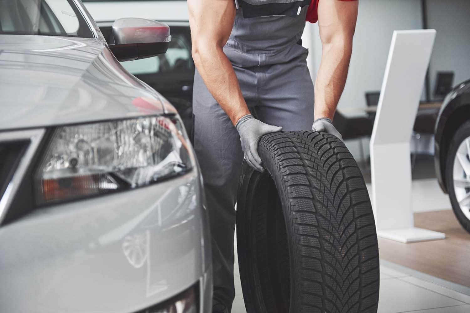 The Cold Facts of Winter Tires | Washington Hyundai in Washington, PA | Hyundai service technician putting winter tires on vehicle